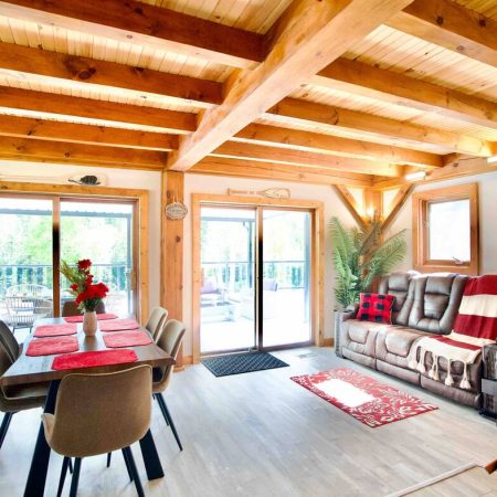 Relax on the comfy reclining sofa near the warmth of the woodstove with easy access to the large Muskoka Cottage patio.